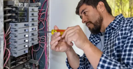 A repairman replacing a fuse box