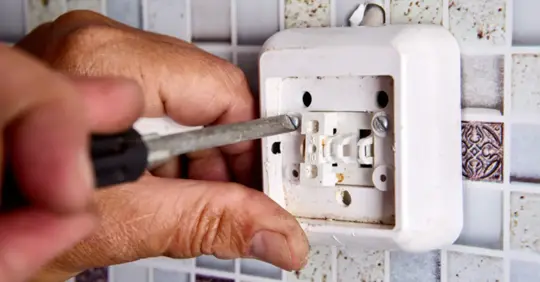 Homeowner changing their light switch